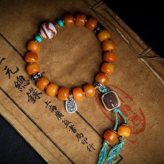 Handcrafted Tibetan yak bone bead bracelet with agate beads and a Zakiram charm