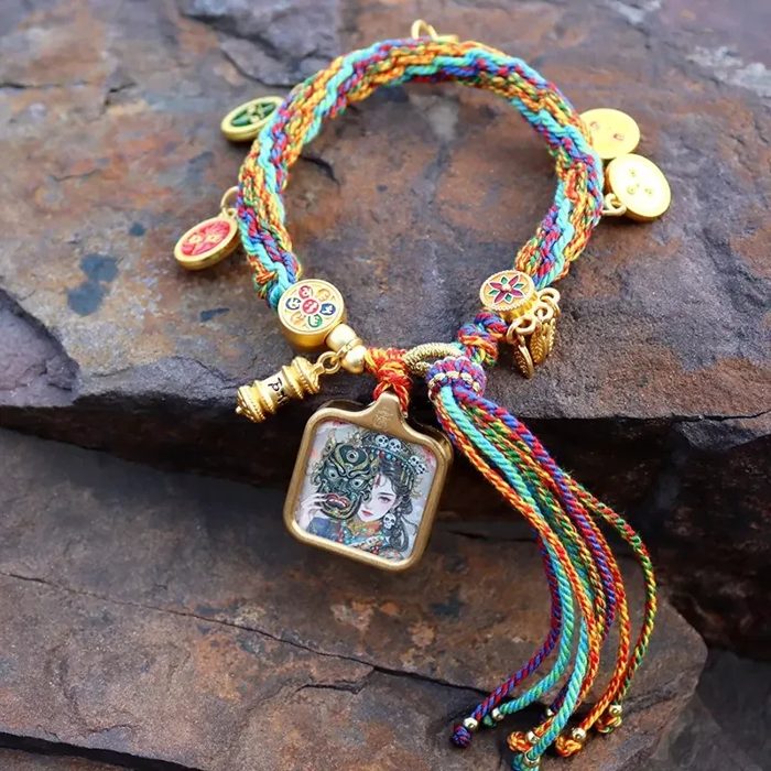 Tibetan handwoven cotton bracelet with a thangka-style protector Buddha charm